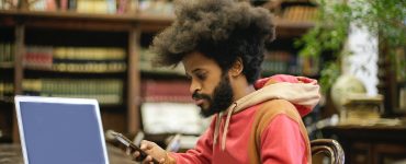 Man In Pink Long Sleeve Shirt Doing Research